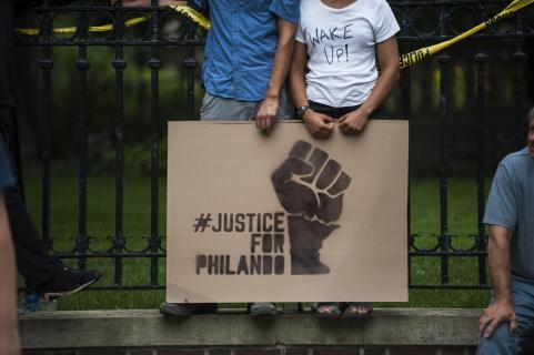 ST. PAUL, MN - JULY 07: A couple hold a sign protesting the killing of Philando Castile outside the Governor's Mansion on July 7, 2016 in St. Paul, Minnesota. Castile was shot and killed the previous night by a police officer in Falcon Heights, MN. (Photo by Stephen Maturen/Getty Images)